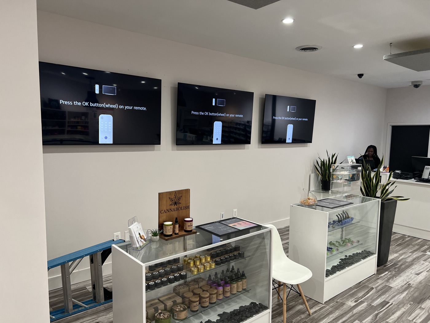 Three TVs mounted level in a row on a commercial build-out